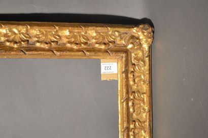 null RVERSE PROFILE FRAME in carved and gilded wood with palmettes and cherub heads...