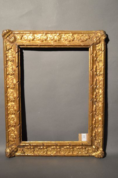 null RVERSE PROFILE FRAME in carved and gilded wood with palmettes and cherub heads...