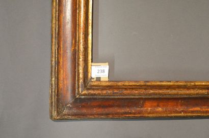 null RVERSE PROFILE FRAME in gilded and painted molded wood with faux tortoiseshell...