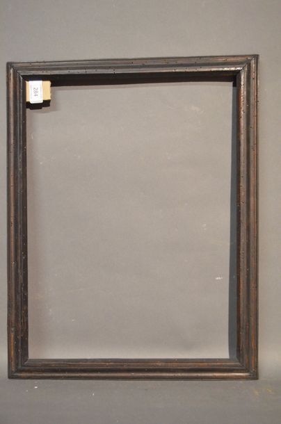 null RVERSE PROFILE FRAME in molded and blackened wood
18th century
(quilted) 33,7...
