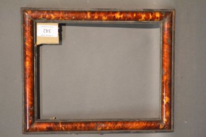 null Moulded and blackened wood frame veneered with tortoiseshell on a pine core,...