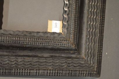 null Moulded and blackened wood frame veneered on a fir wood core with guilloche...