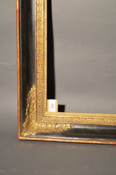 null FRAME in moulded wood and black and gold stucco with soft profile and cartouche...
