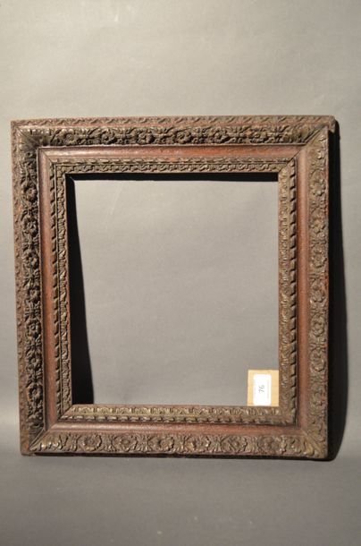 null FRAME in carved and stained oak with decoration of flowers, ribbons and acanthus...