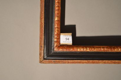 null RVERSE PROFILE FRAME in black and gold carved wood with gadroons decoration...