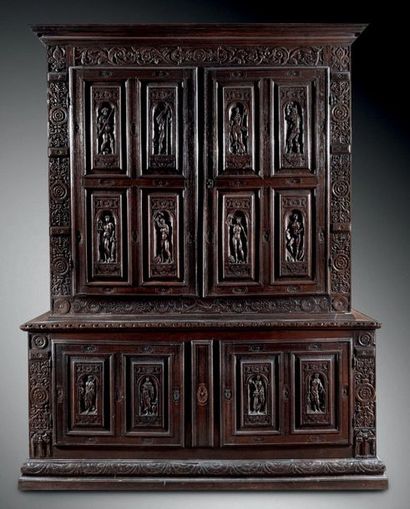 An important two-piece cabinet in carved...
