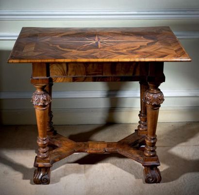 Carved walnut and walnut veneer table with...
