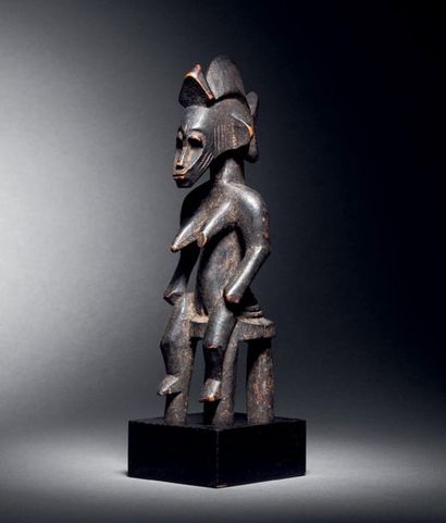 null Ɵ Seated female figure,
Senoufo, Republic of Côte d'Ivoire
Wood with brown patina
H....