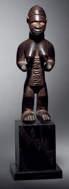 null Female standing Bembe figure,
Democratic Republic of the Congo
Wood with brown...