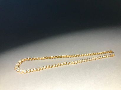 null Articulated necklace in 750 thousandths yellow gold set with a line of seventy-five...