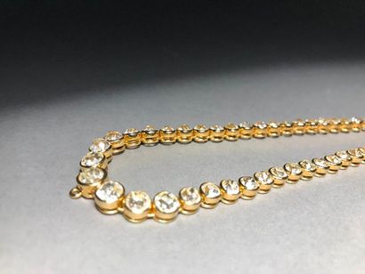 null Articulated necklace in 750 thousandths yellow gold set with a line of seventy-five...