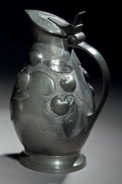 Albert ERMENAULT (actif au XXe siècle) A pewter pitcher with an ovoid body and a...