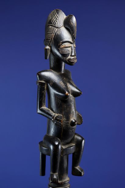 null 
Tefalipitya cultivator's cane carved at the top with a female figure sitting...