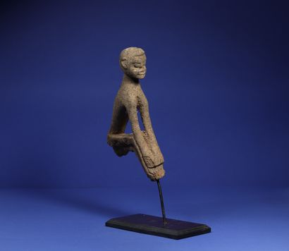  Top of a divination stick showing a seated...