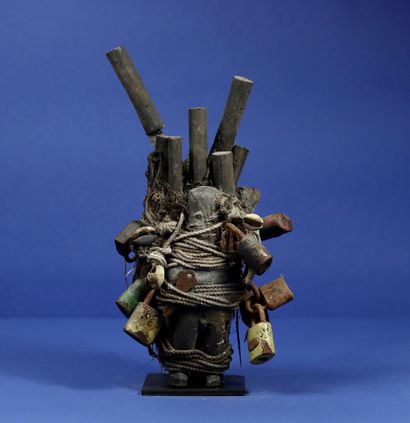null 
Ritual bundle incorporating two wooden statuettes with a crusty patina attached...