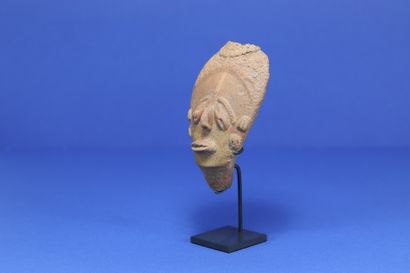 null 
Small funerary head with drooping eyes, the back of the skull with a marked...