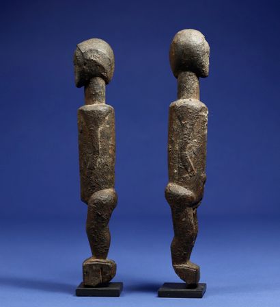  Charming couple of statuettes with simplified features. Wood with a crusty patina....
