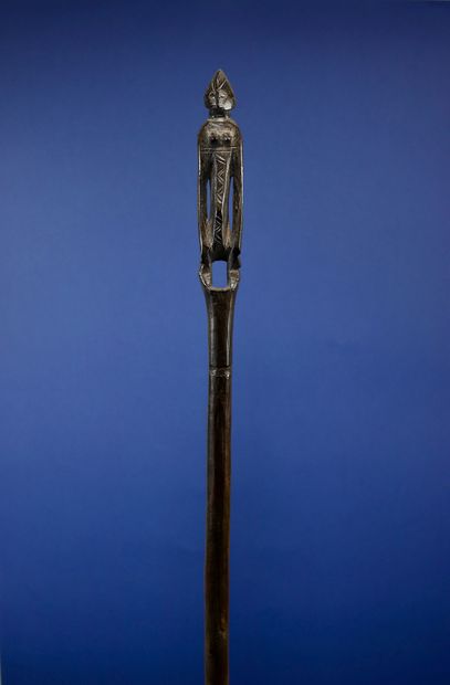 null 
Poro cane carved at the top with a female figure. 



Wood with a deep patina...
