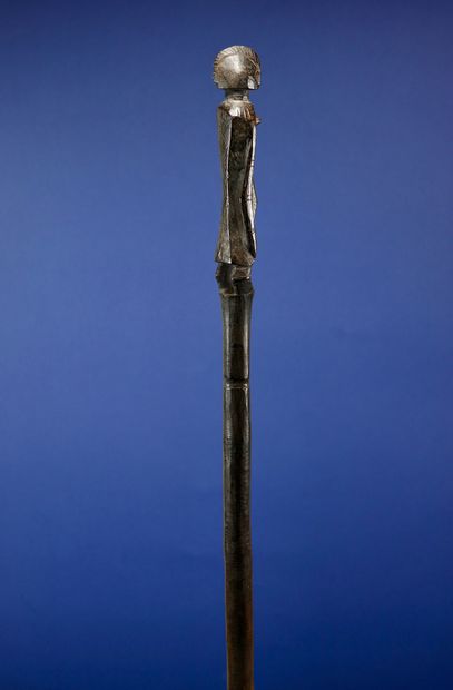 null 
Poro cane carved at the top with a female figure. 



Wood with a deep patina...