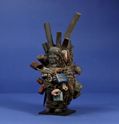null 
Ritual bundle incorporating two wooden statuettes with a crusty patina attached...