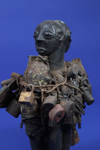  Votive figure representing two monoxylean back-to-back figures covered with a black...