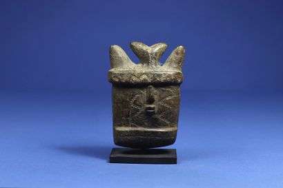 null 
Rare small mask showing a horned face with scarred cheeks, soapstone with brown...