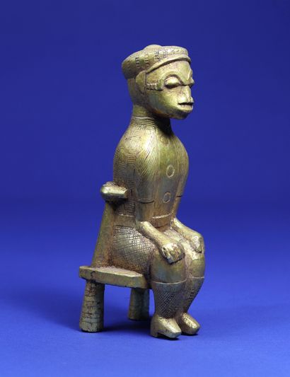  Statuette representing a character sitting...