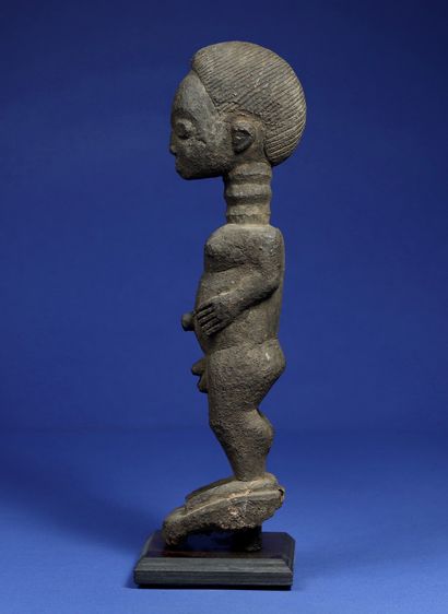 null 
Male statue in a standing position, entirely covered with a crusty patina,...