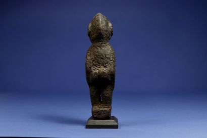  Divination statuette, the details of the sculpture disappearing under a thick black...