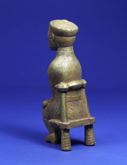 null 
Statuette representing a character sitting on a chair, dressed in European...