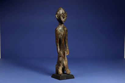  Male statuette sitting on a stool, the legs merging with the front feet of the seat....