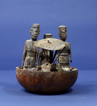 null 
Votive half calabash with three wooden statuettes, a dog skull and an iron...