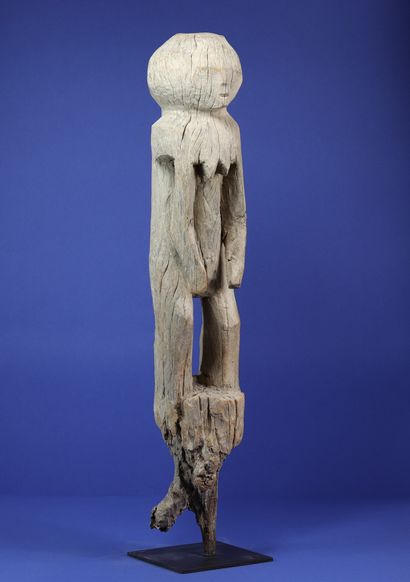 null 
Post representing a standing female figure treated in a few simple volumes,...