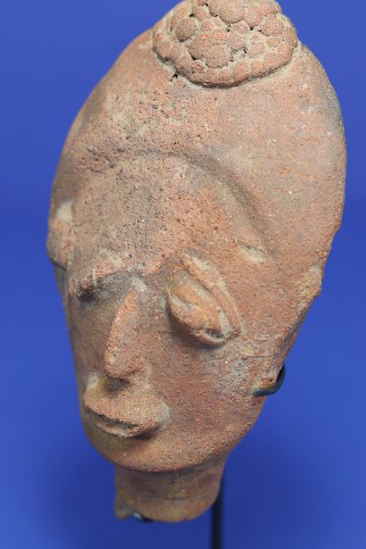 null 
Small funerary head with drooping eyes, the back of the skull with a marked...