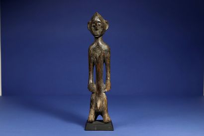 null 
Male statuette sitting on a stool, the legs merging with the front feet of...