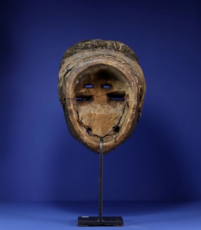 Mask with powerful volumes, bulging eyes, blunt nose, open mouth showing teeth and...