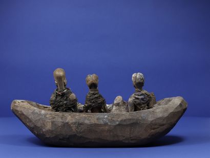 null 
Wooden votive boat with three figures surrounded by fabric and strings, two...