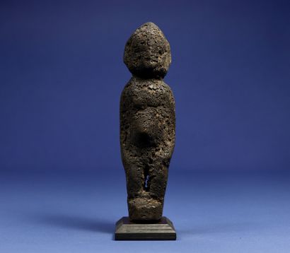  Divination statuette, the details of the sculpture disappearing under a thick black...