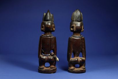  Pair of ibedji statuettes. Wood, beads and cowrie shells, aluminium inserts in the...
