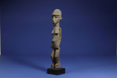  Statuette representing a standing female figure. Wood with a crusty patina. Lobi,...