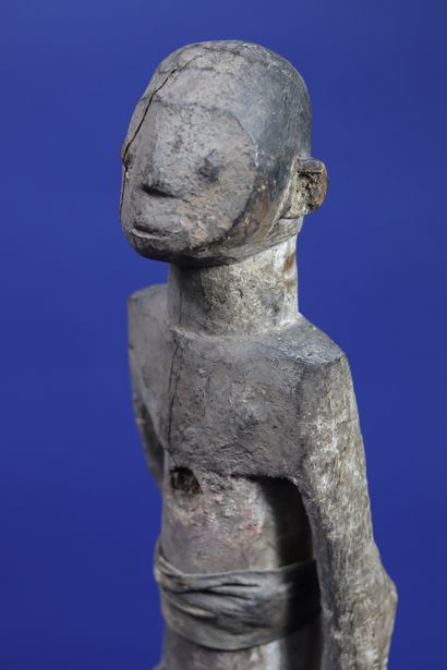 null 
Wooden statue representing a standing figure dressed in a cloth skirt and a...