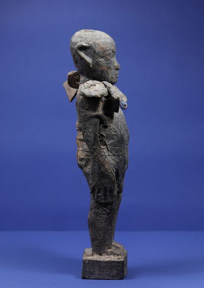  Wooden statue representing a standing male figure wearing a necklace made of fragments...