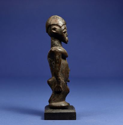  Male statuette in standing position. Wood with black patina. Lobi, Burkina Faso....