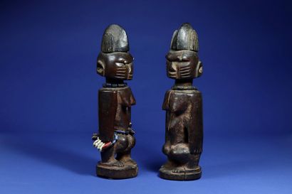  Pair of ibedji statuettes. Wood, beads and cowrie shells, aluminium inserts in the...