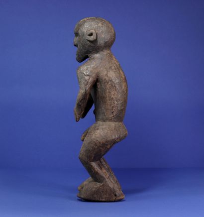  Powerful male statue representing a standing figure, legs bent and shoulders projected...