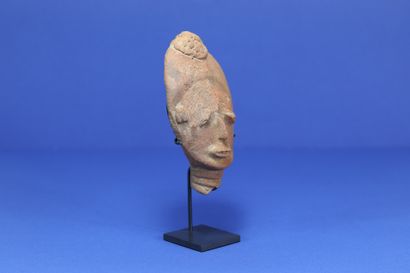  Small funerary head with drooping eyes, the back of the skull with a marked concavity....