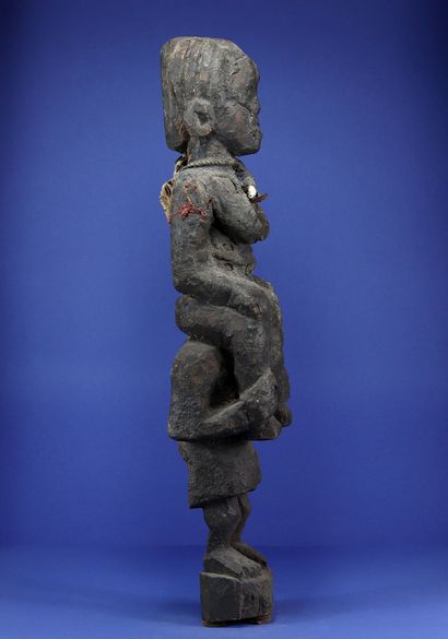 null 
Interesting wooden statue representing a standing figure carrying another on...