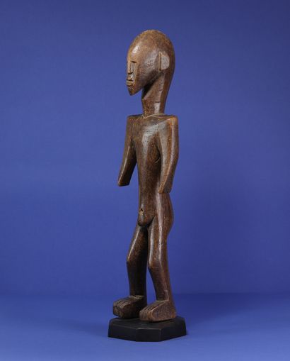 null 
Male statue of a standing figure with a tense silhouette, square shoulders...