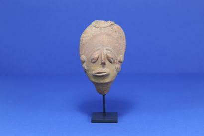  Small funerary head with drooping eyes,...