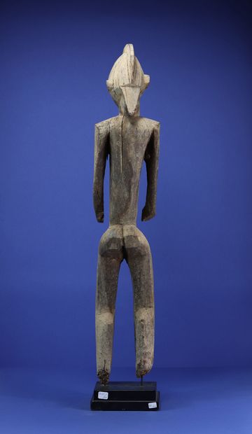  Superb statue representing a standing male figure, the arms free of the body, the...
